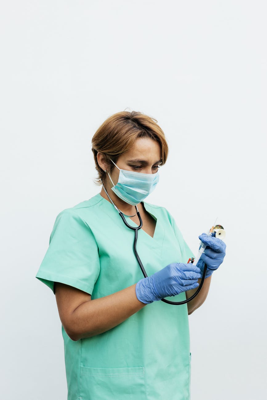 woman wearing a scrub suit holding a stethoscope
