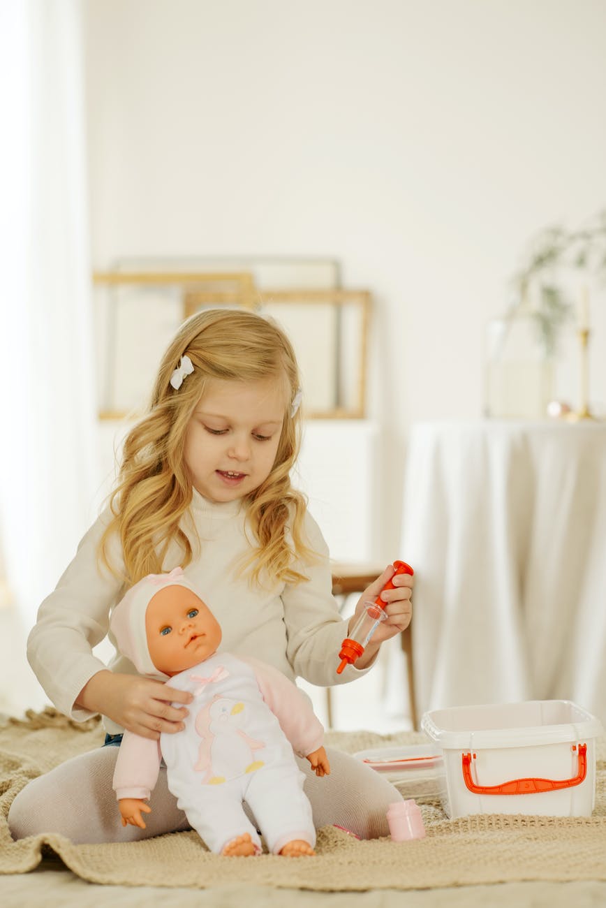girl playing with baby doll