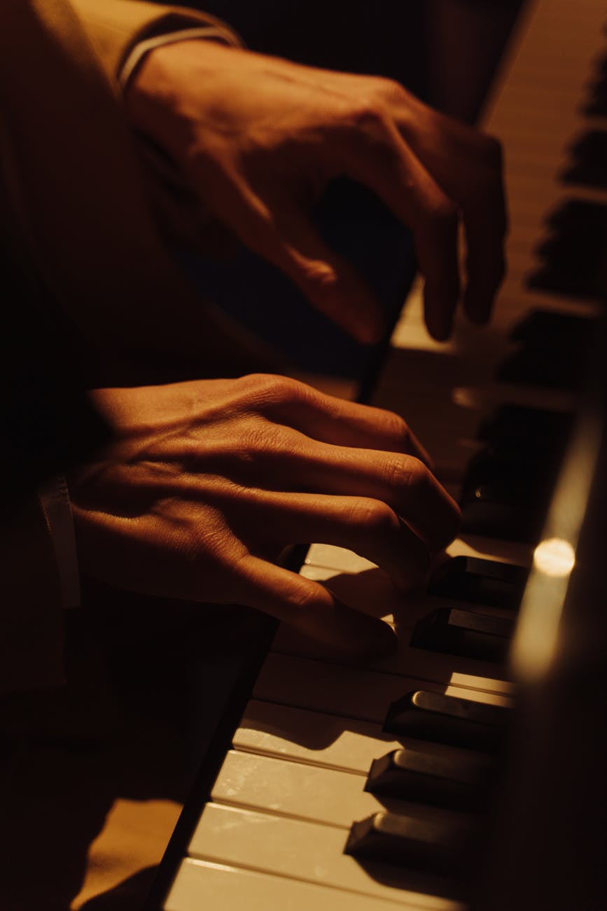 close up shot of a person playing piano