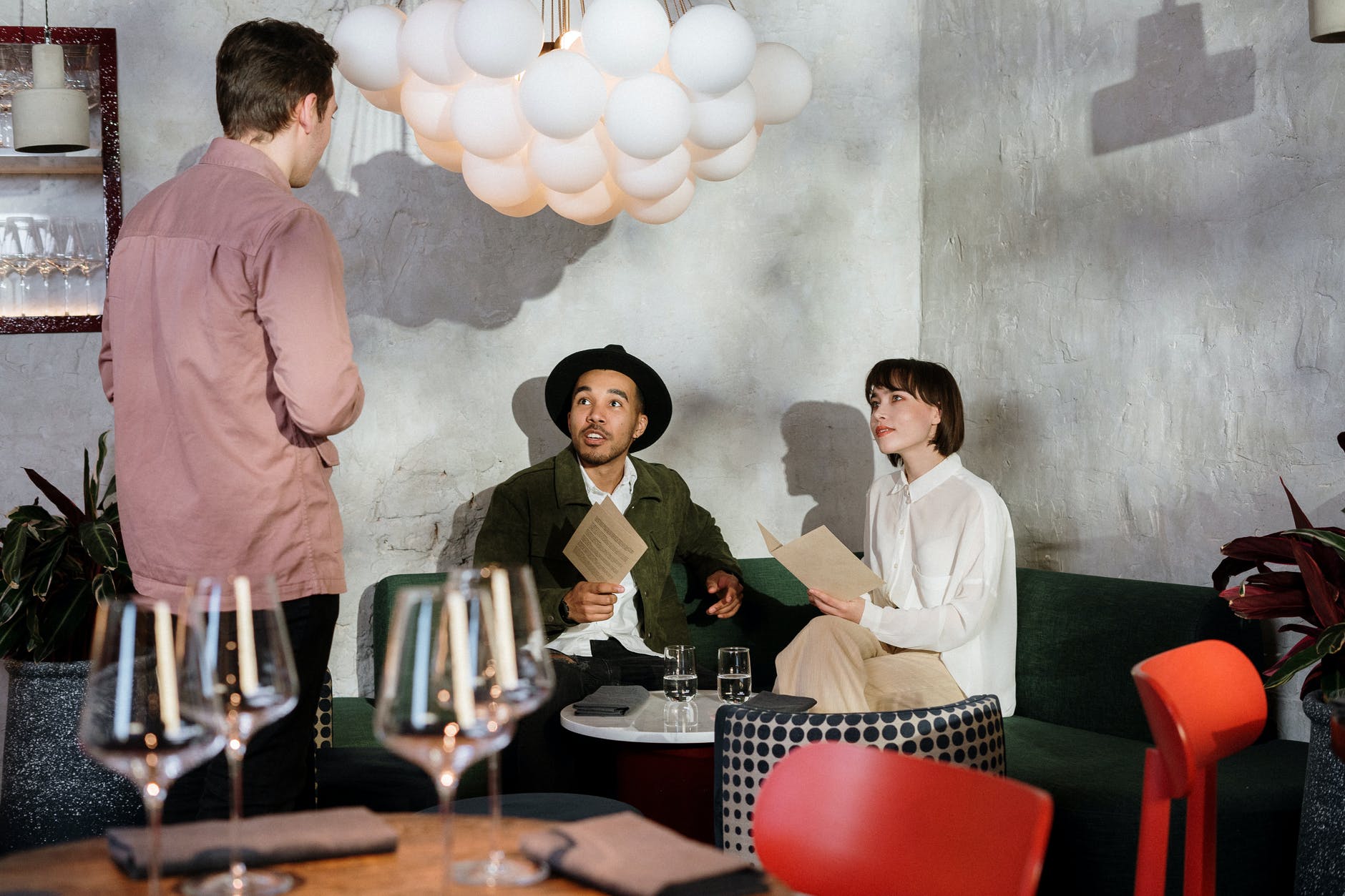 man in white dress shirt standing beside woman in pink long sleeve shirt