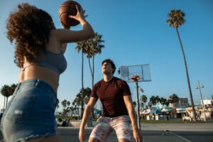 a young man and woman playing basketball