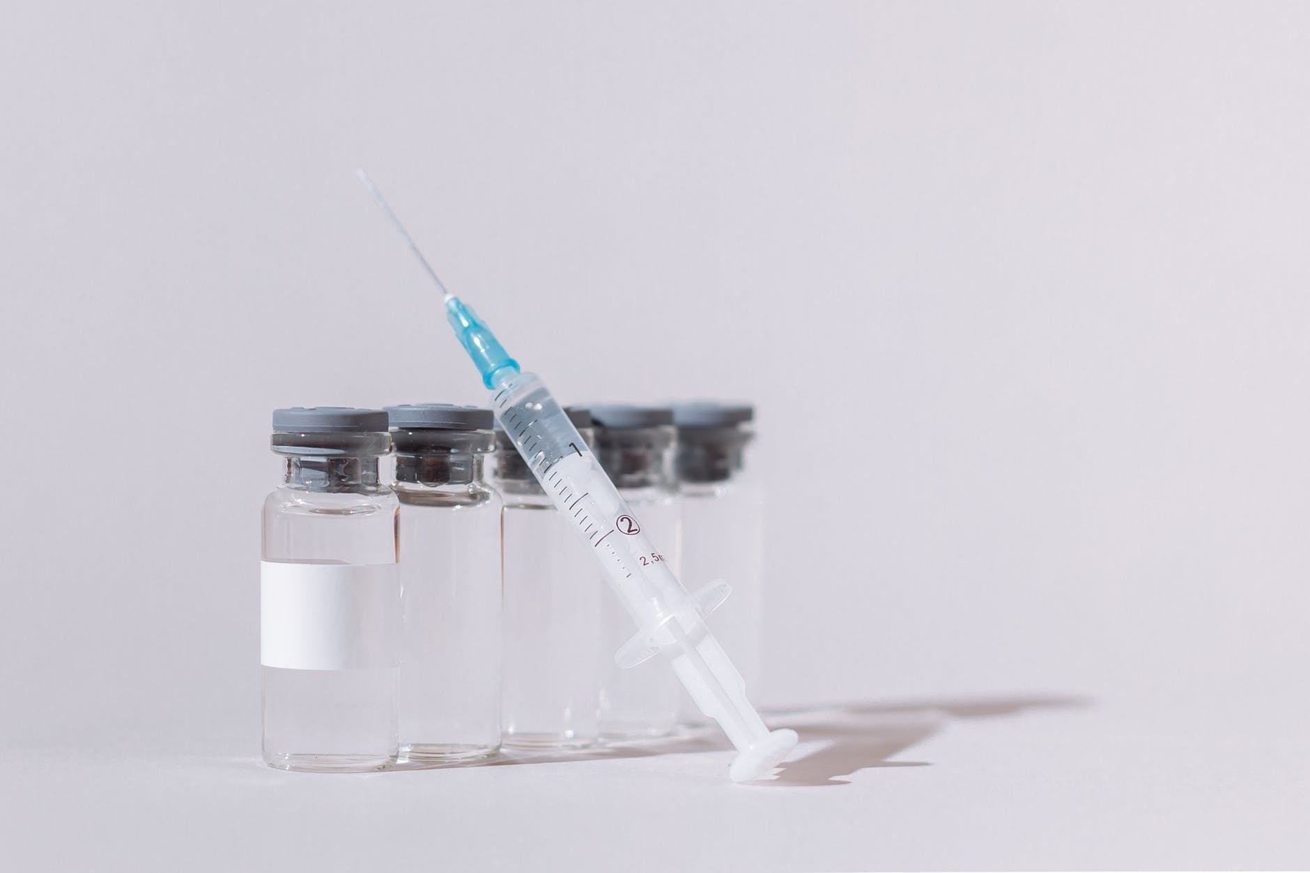 covid vaccine bottles and syringe