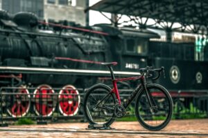 black and red road bike near black train