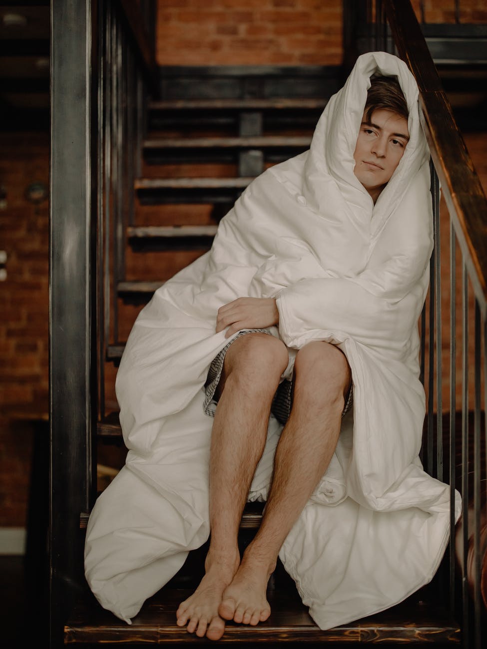 woman in white hijab sitting on brown wooden chair