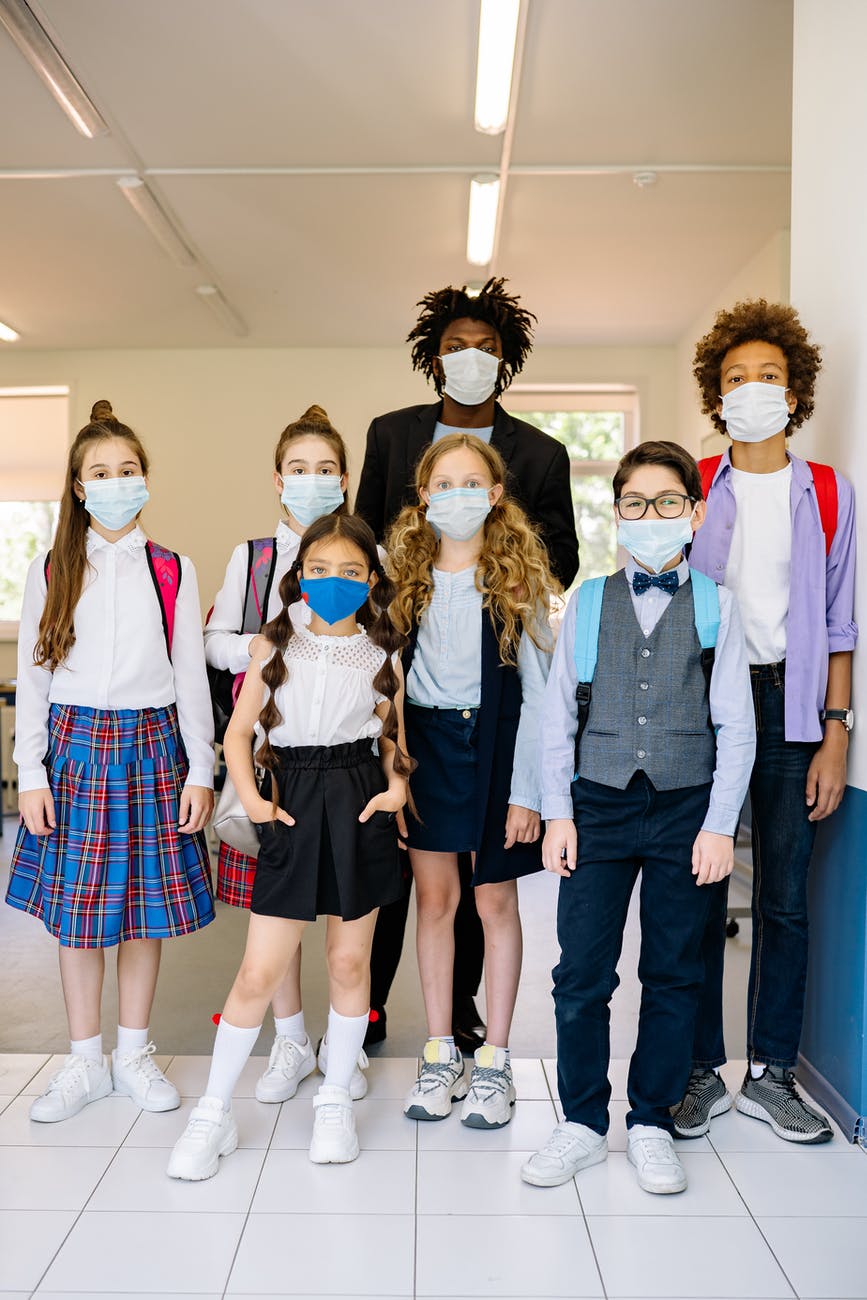 a teacher and students wearing face masks