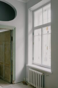 shiny window above radiator in new apartment