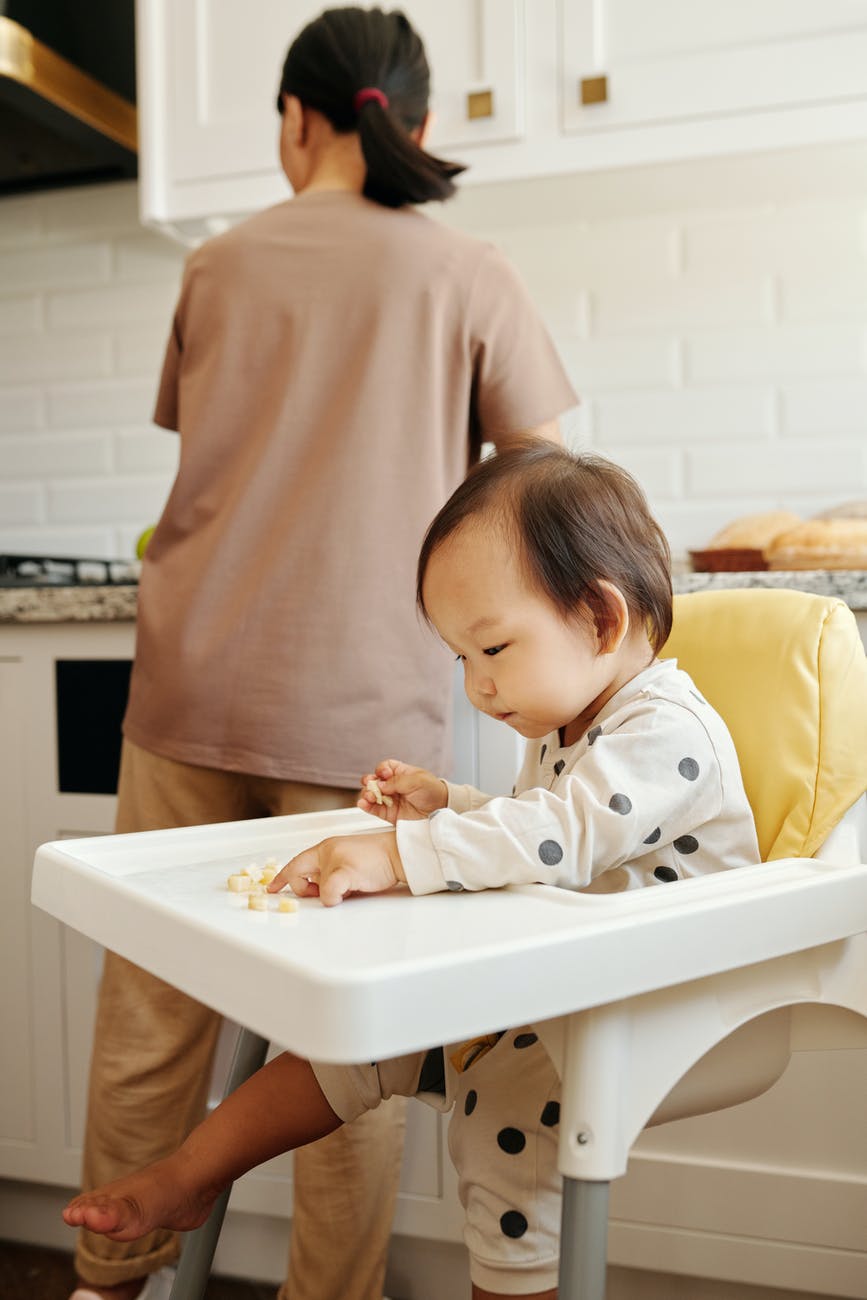 a toddler sitting on high chair