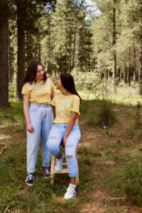 women in the forest wearing matching outfits