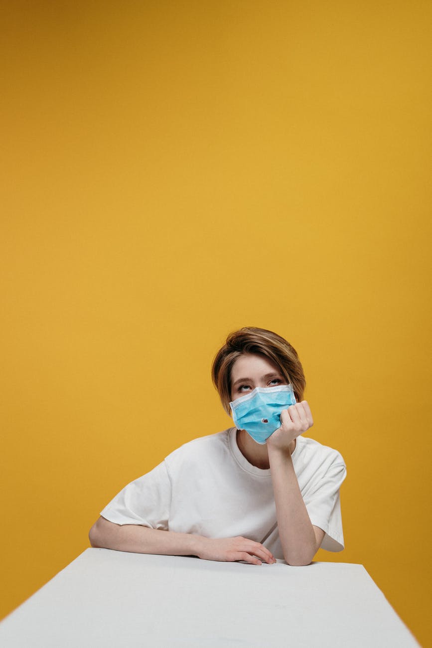 woman in white crew neck t shirt wearing face mask
