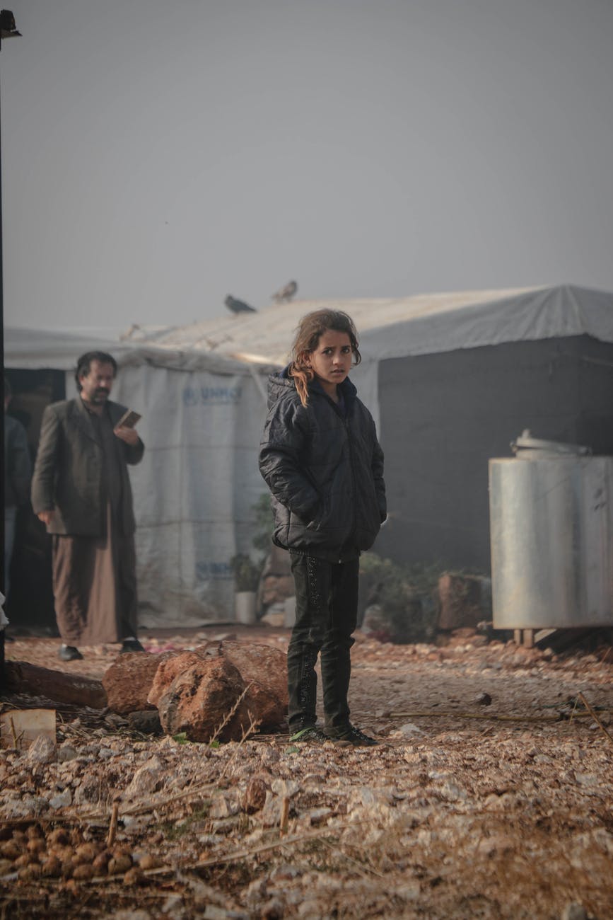 young girl standing near tents