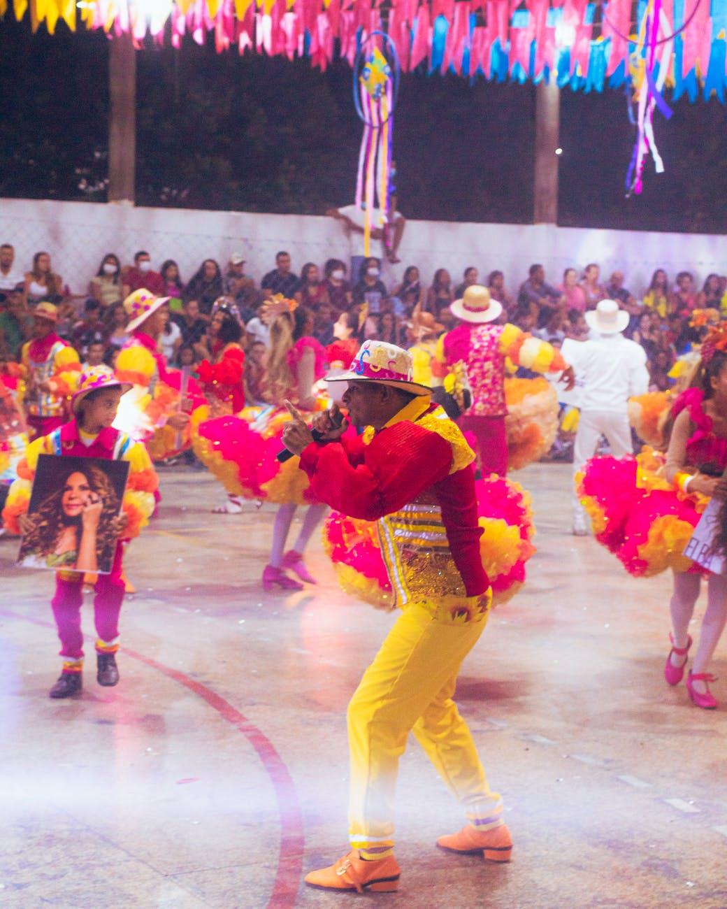people in colorful costume dancing on the court floor