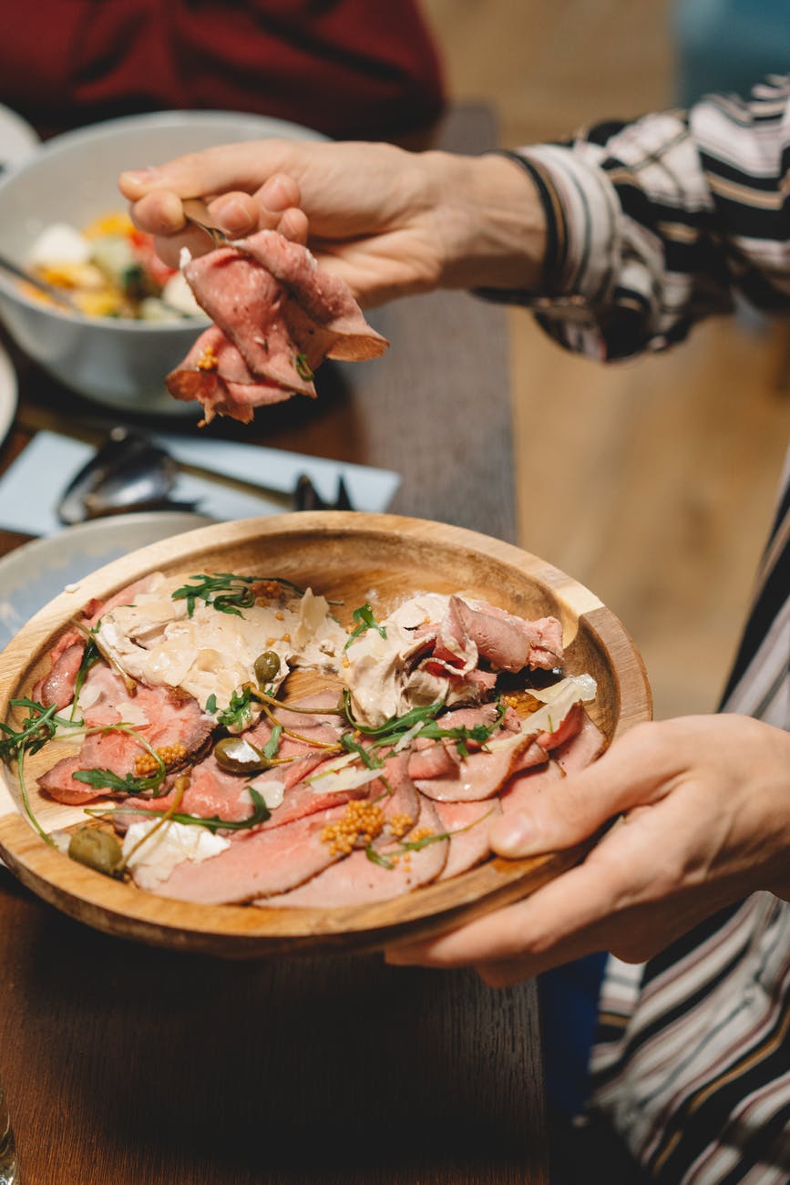 a plate of sliced ham served in dinner