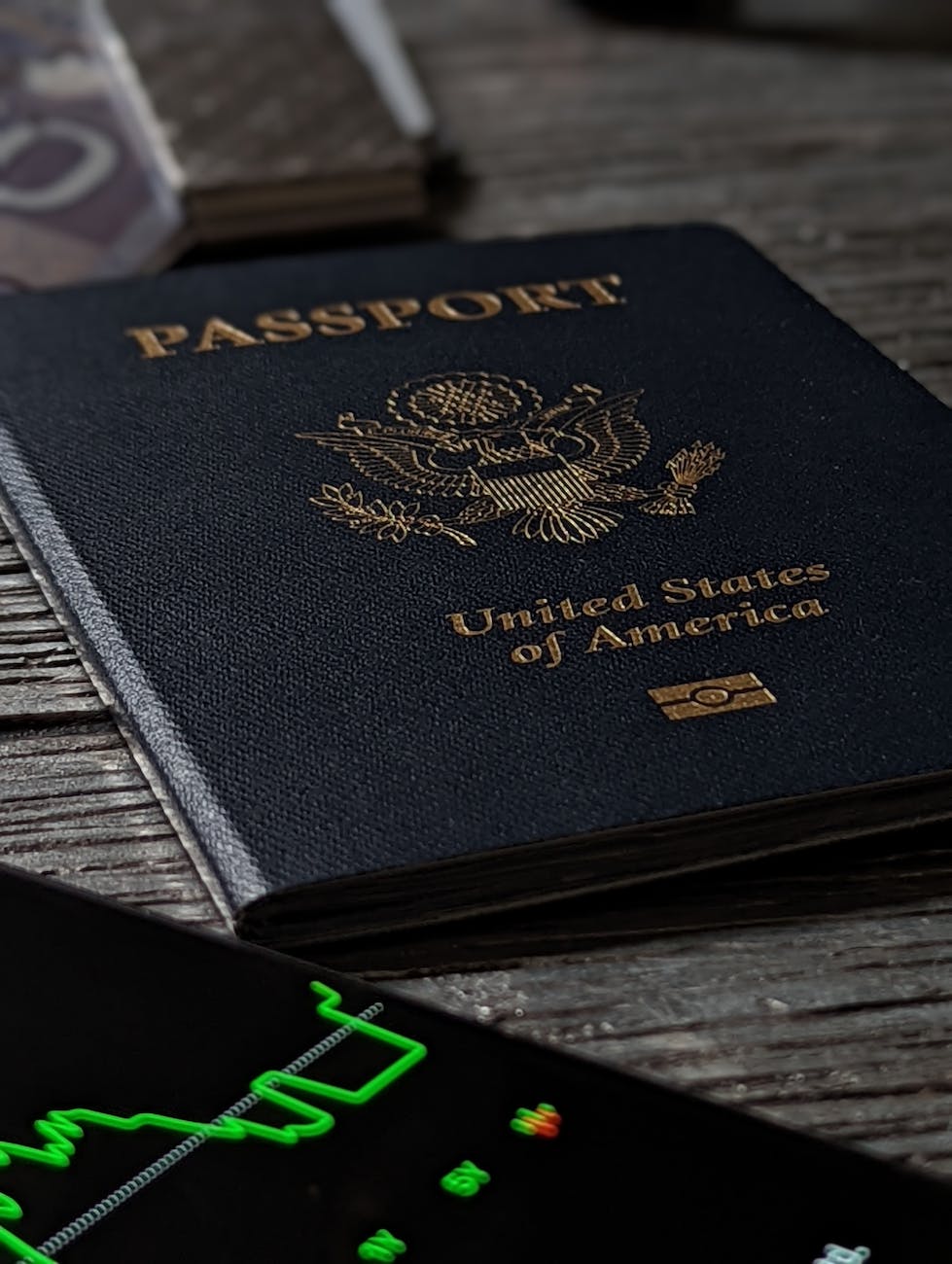 black and gold passport on black wooden table