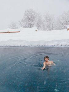 woman swimming alone while snowing
