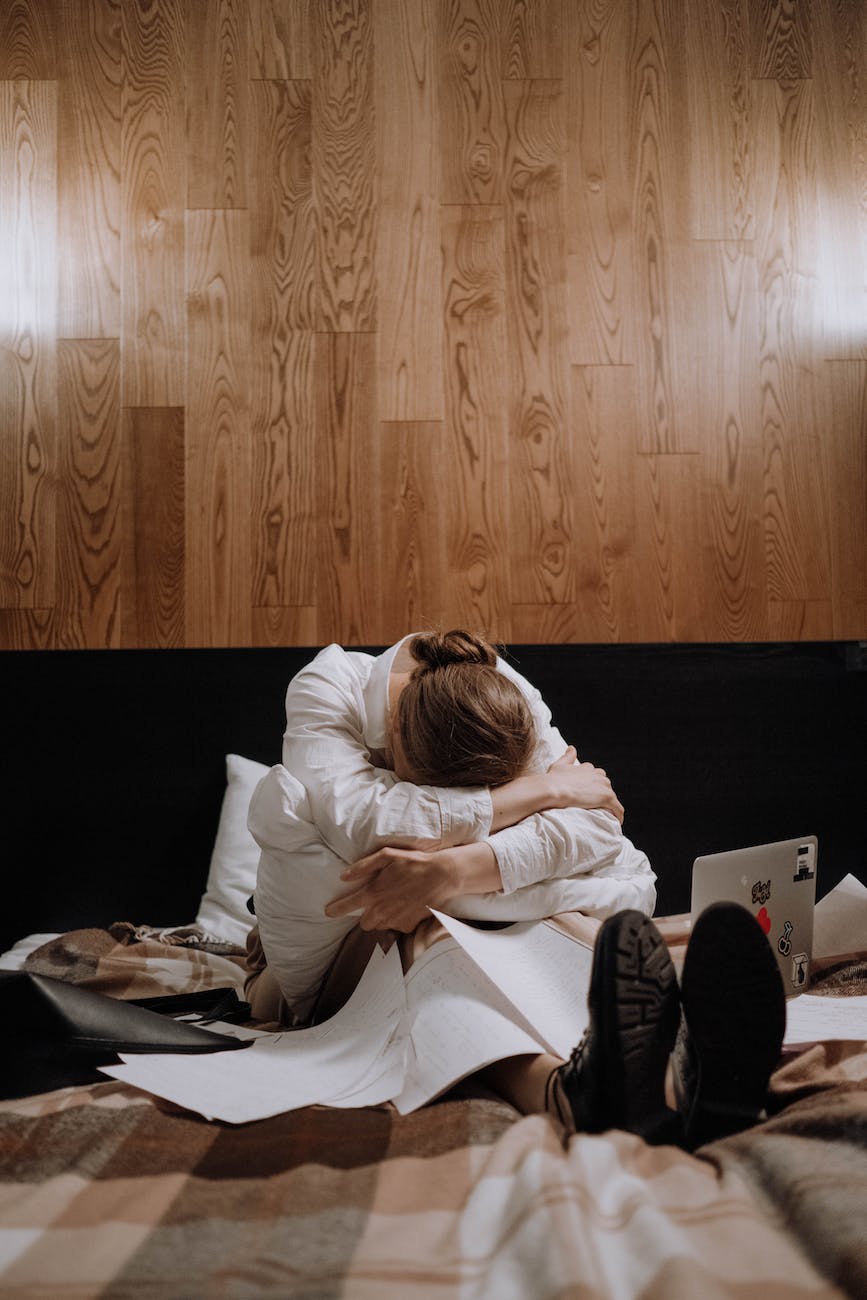 tired woman sitting on the bed