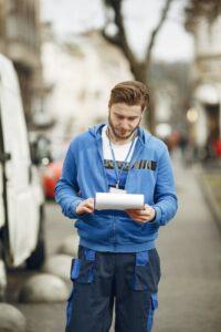 delivery man reading invoice