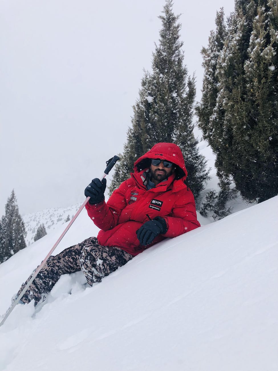 a man sitting on snow covered ground