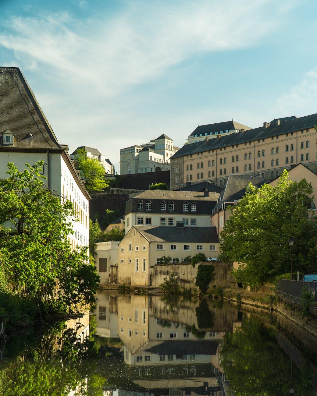 white and brown concrete buildings beside the river