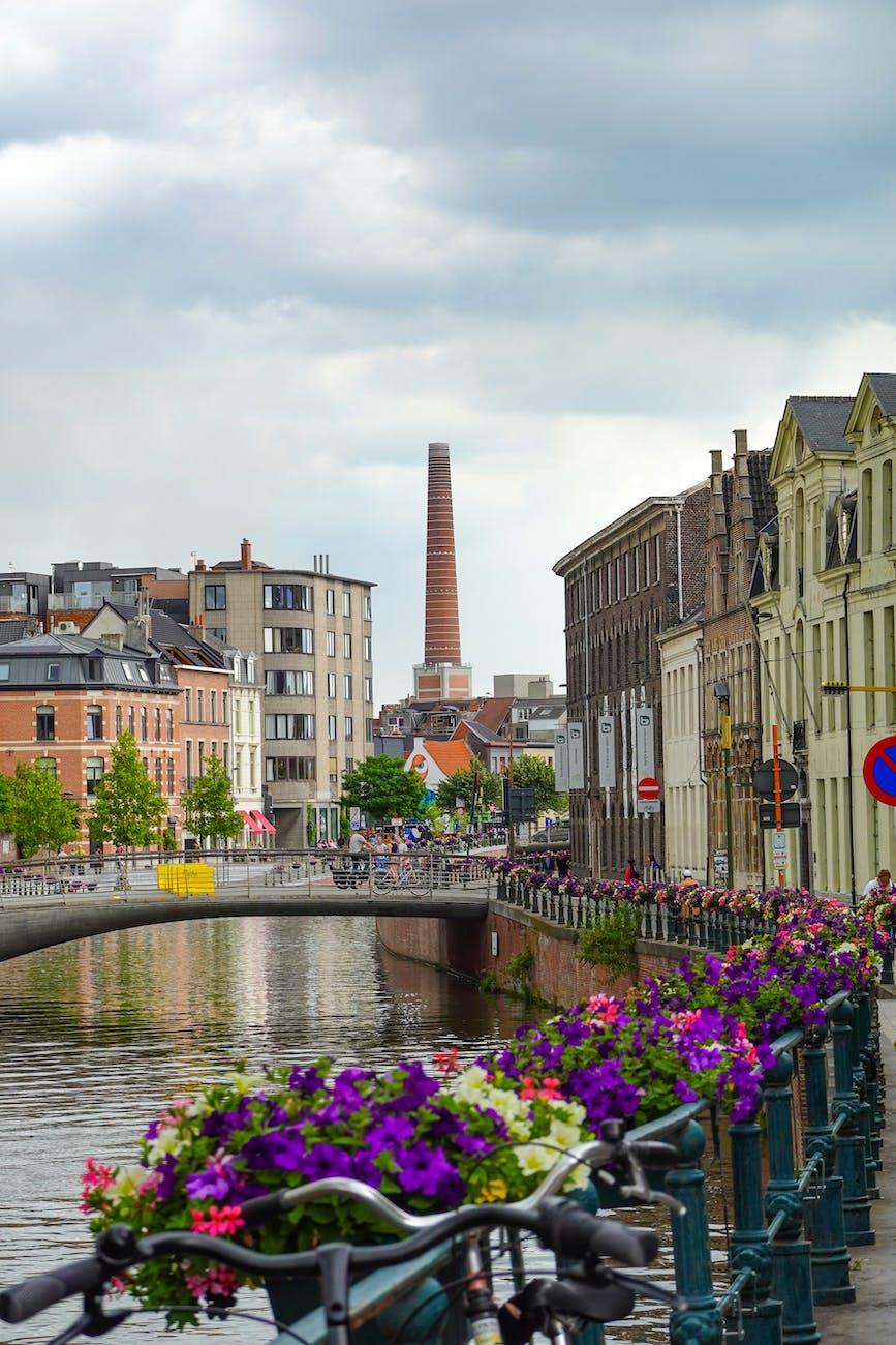 a river between old concrete buildings in the city
