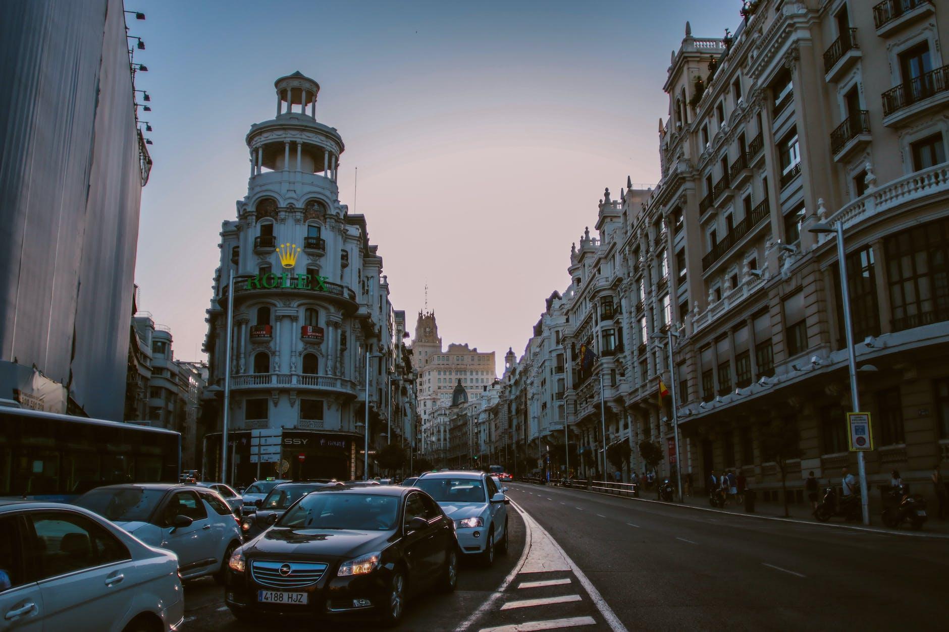 old buildings along the concrete road with traffic