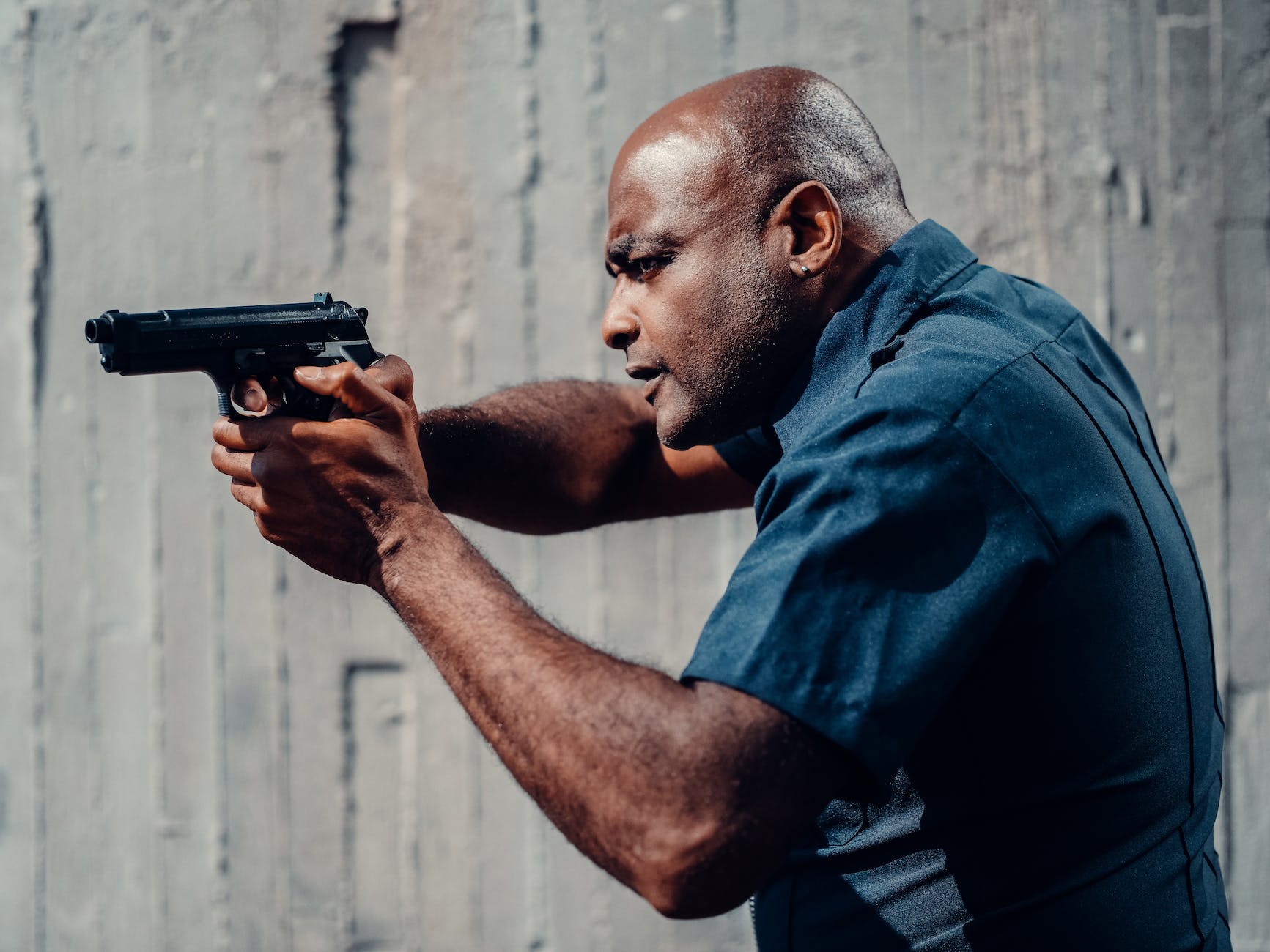 man in blue uniform holding a gun