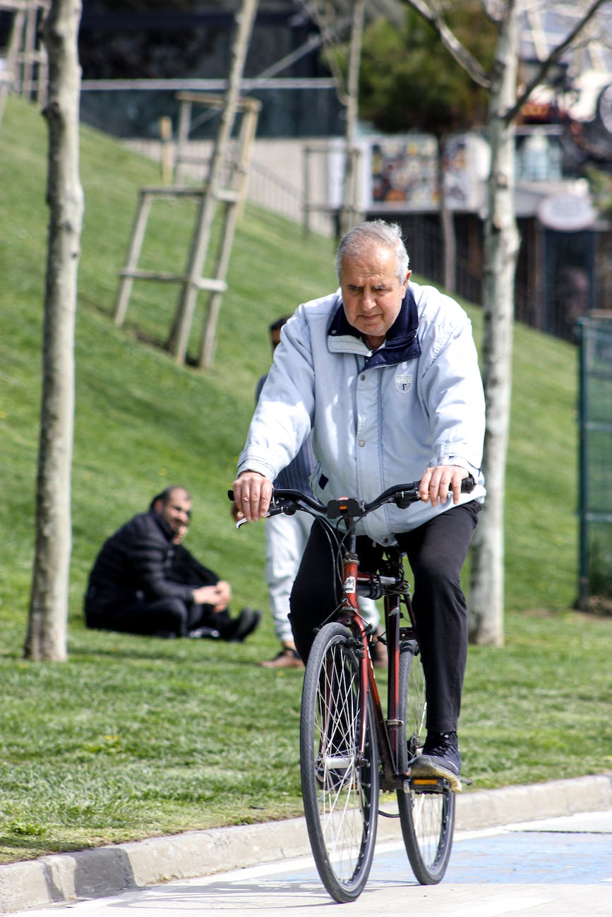 a man in white jacket riding a bicycle