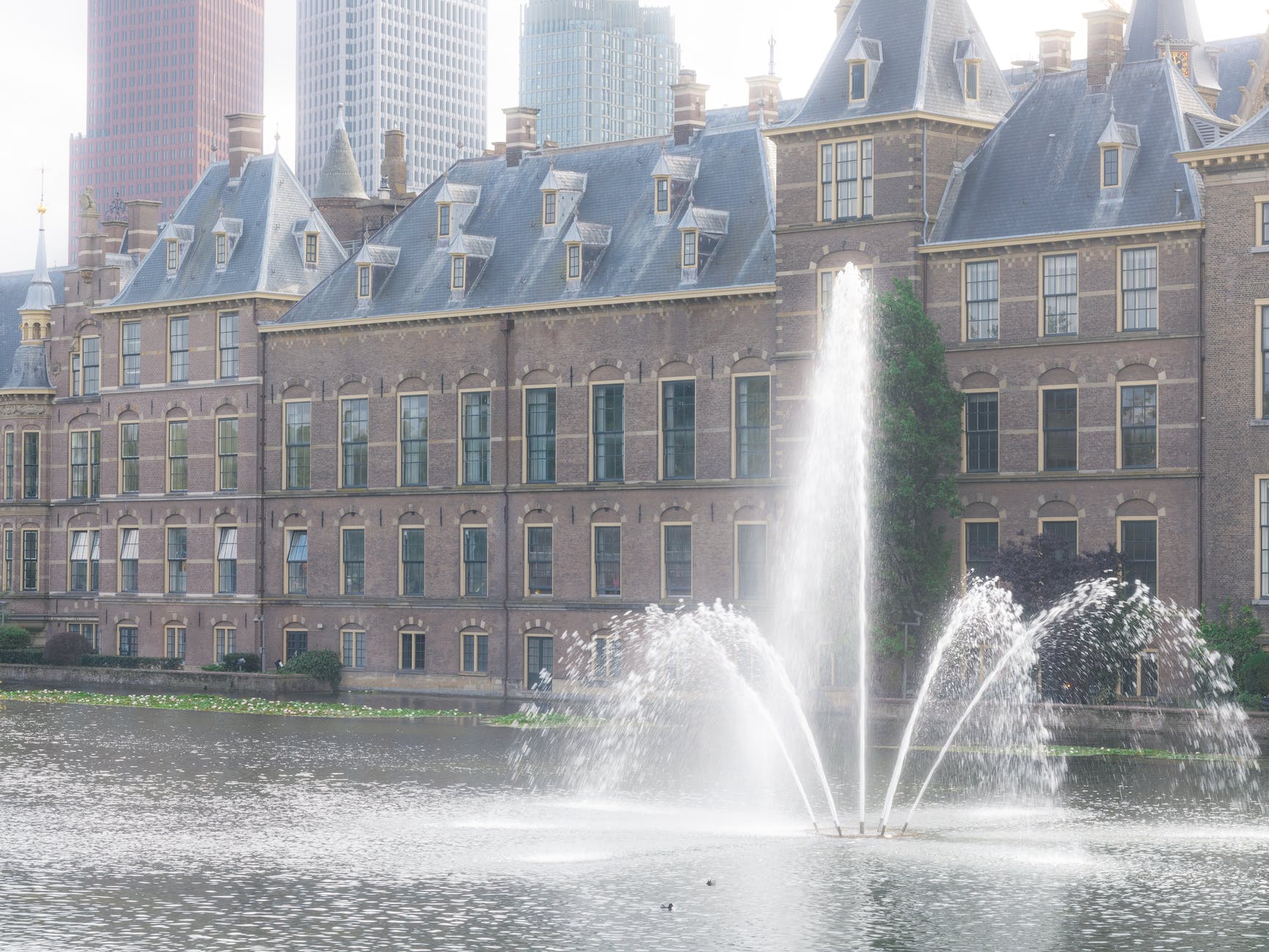 water fountain in front of brown concrete building