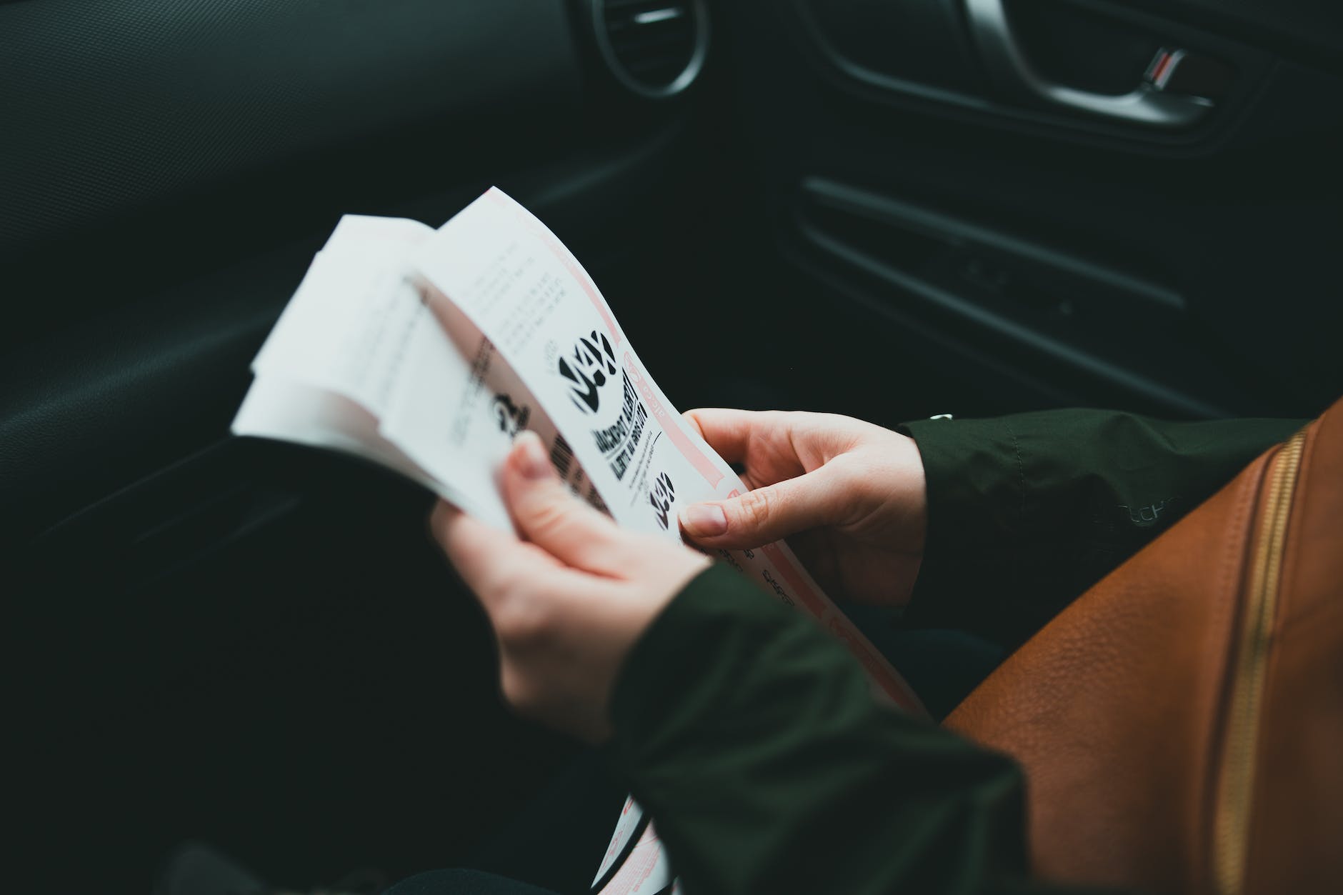 photo of a person holding tickets