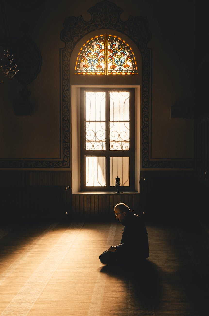 photo of man kneeling while praying