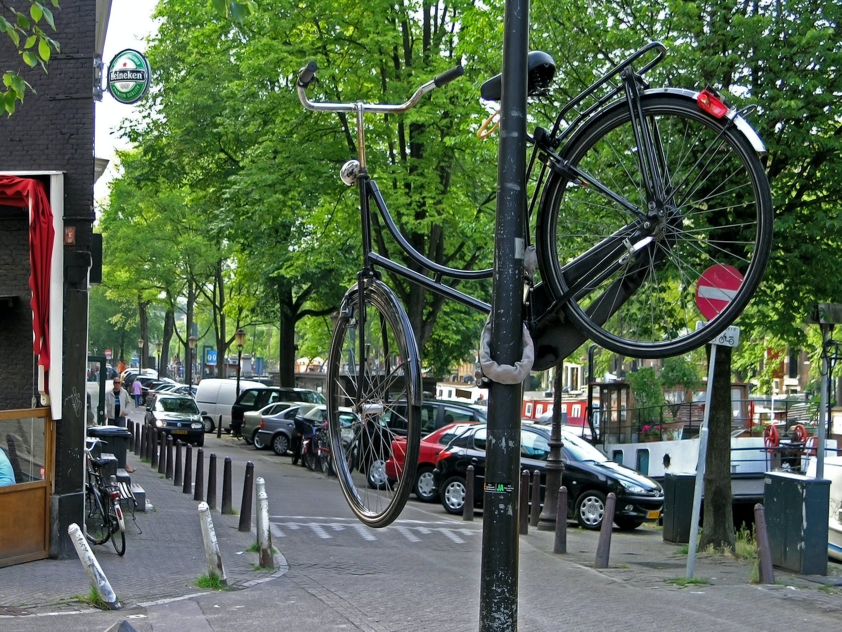 a bicycle chained to a metal post