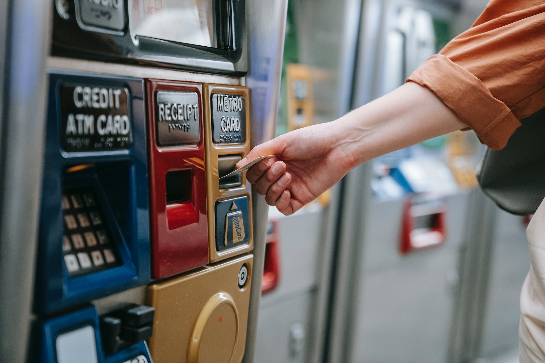 person inserting card on an automated machine