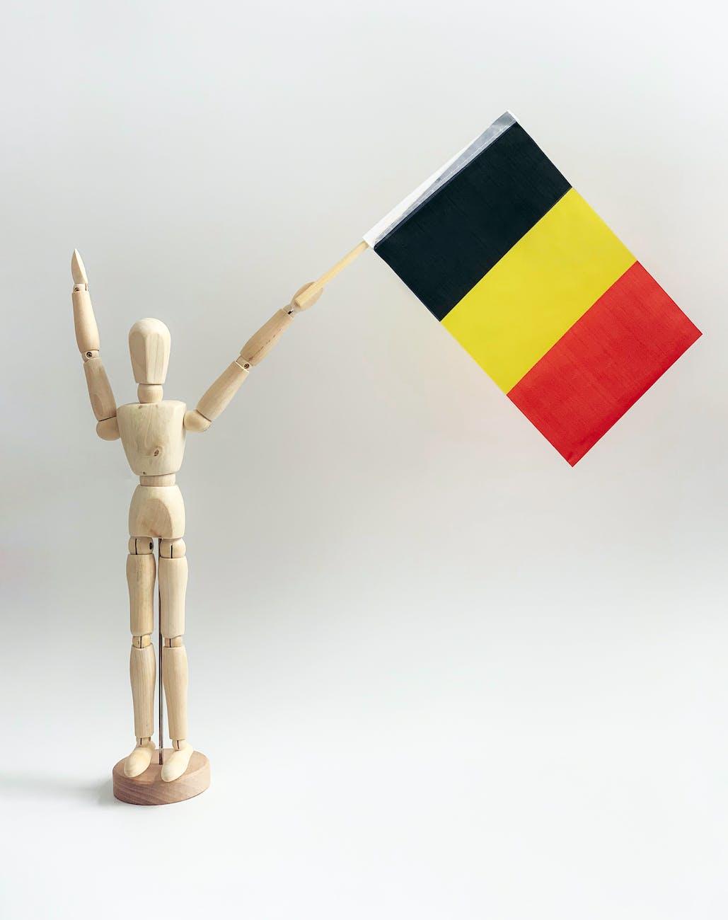 a wooden dummy holding a belgium flag