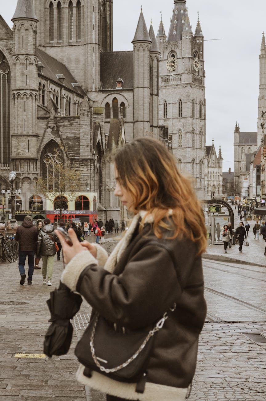 woman in black jacket standing on the street