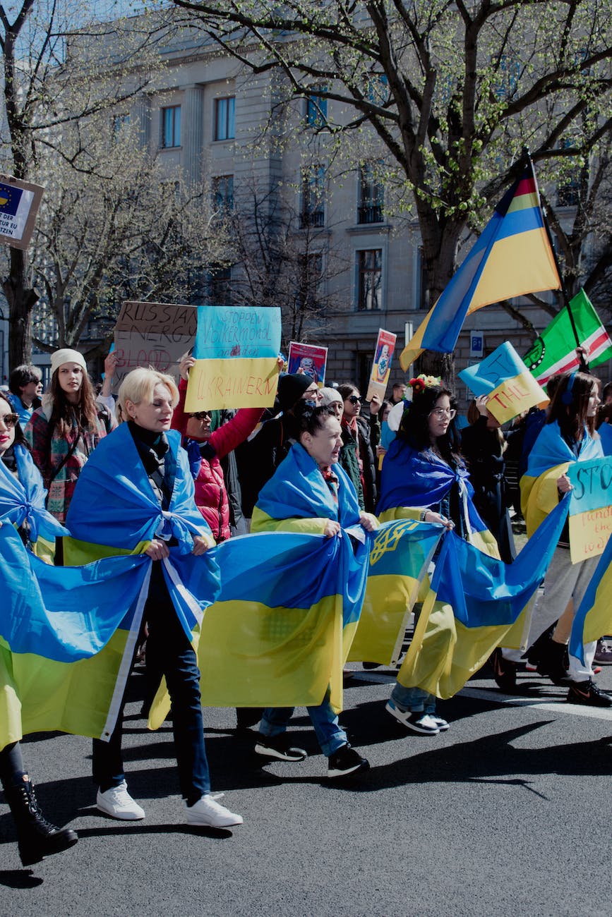 people doing a rally while holding ukraine flag