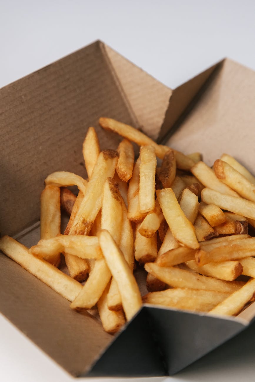 a box of delicious french fries in close up photography