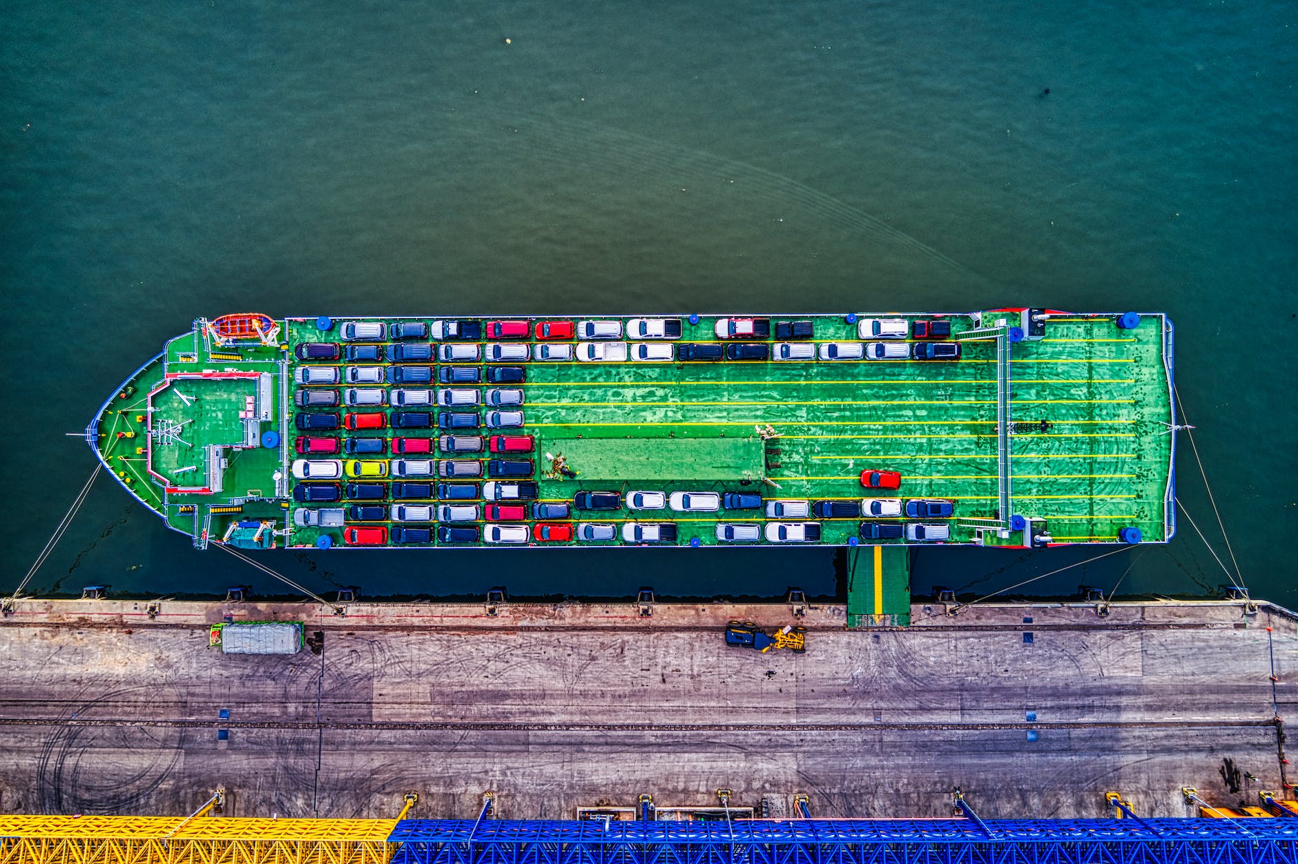 green cargo boat beside dock