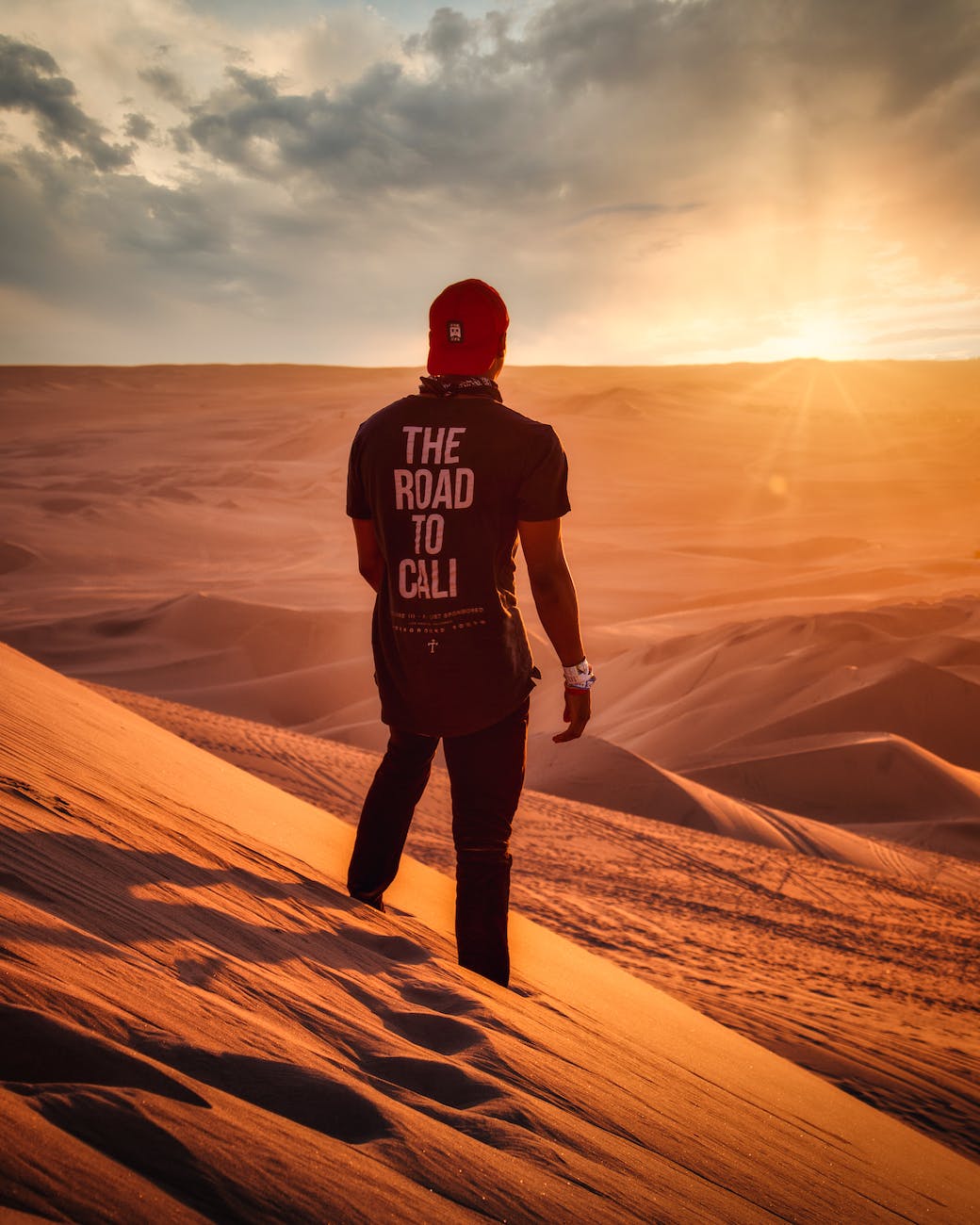 photo of man standing on desert