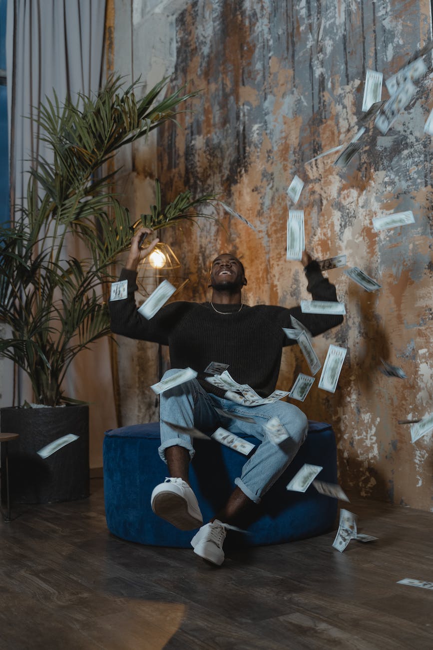 photo of happy man in black long sleeve shirt winning cash money