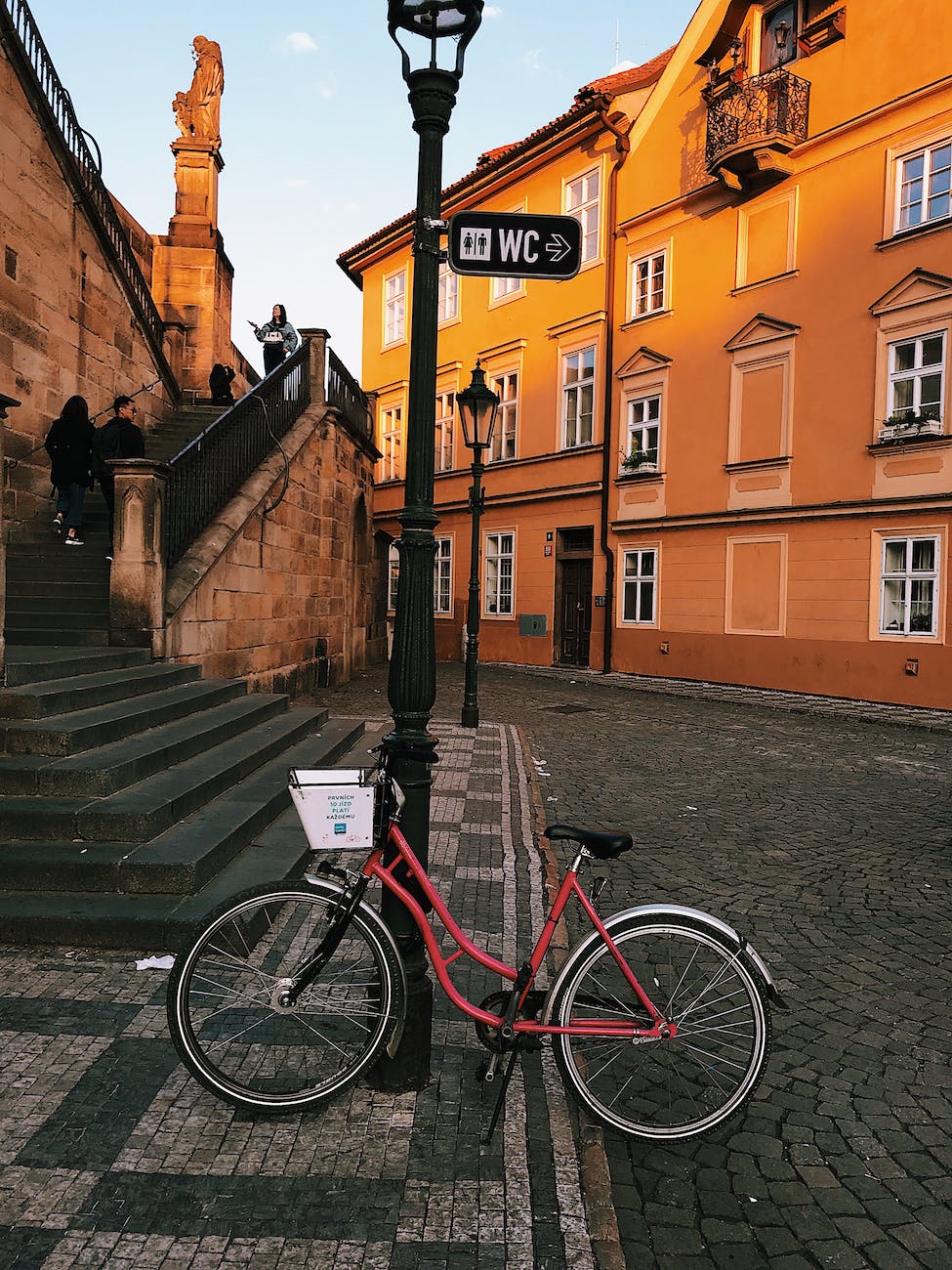 red bicycle parked on street