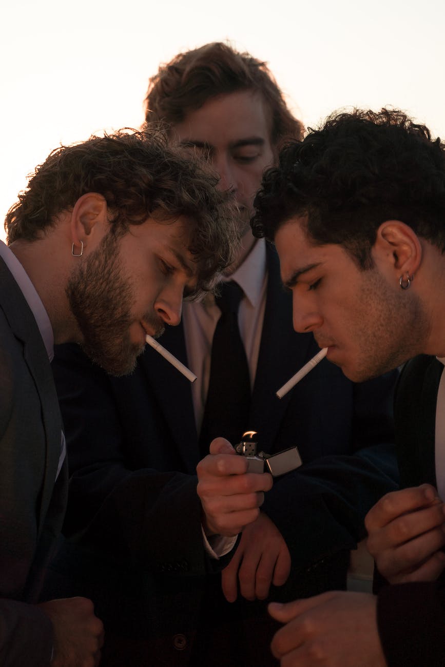 man lighting up his friends cigarette