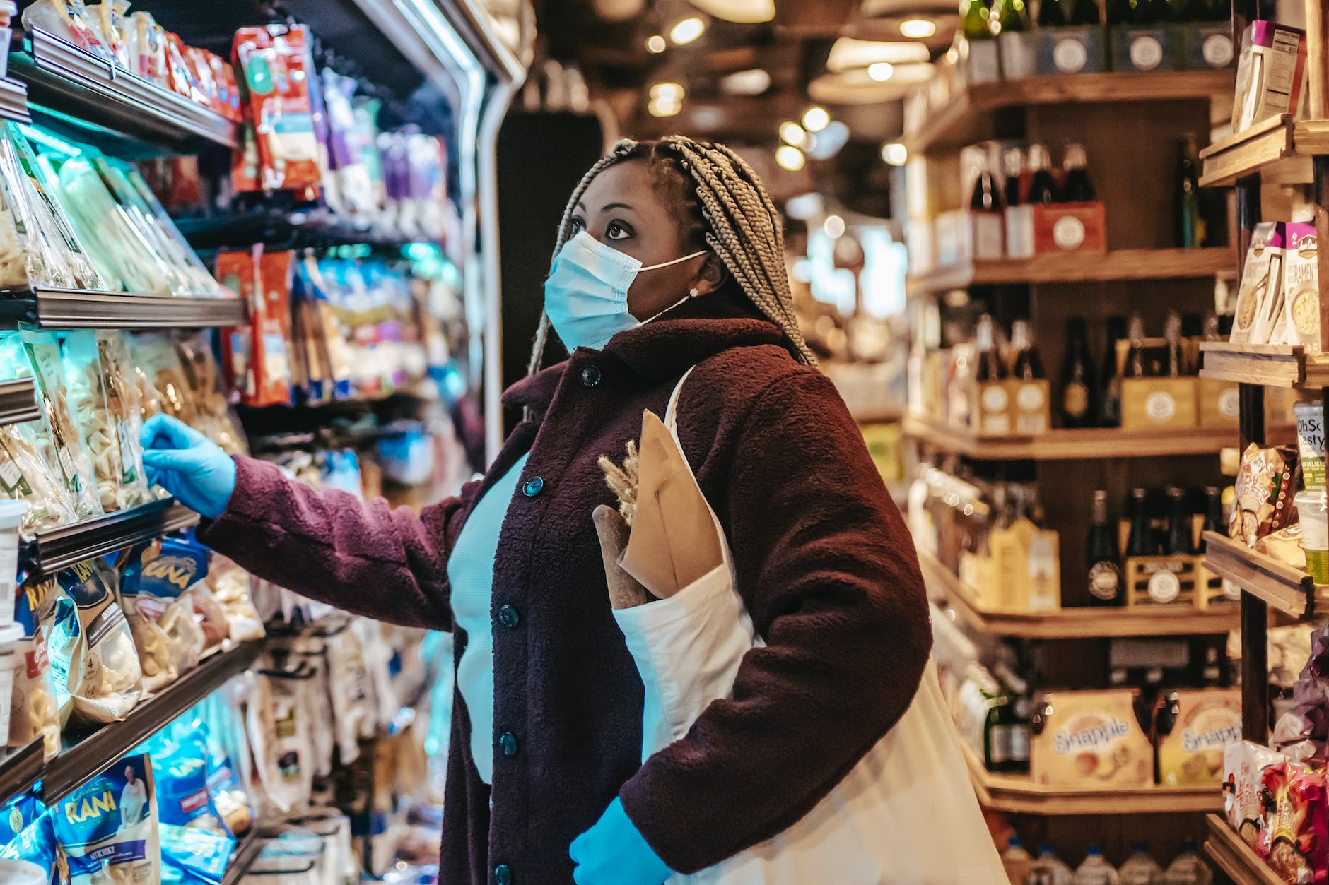 black woman choosing products in supermarket