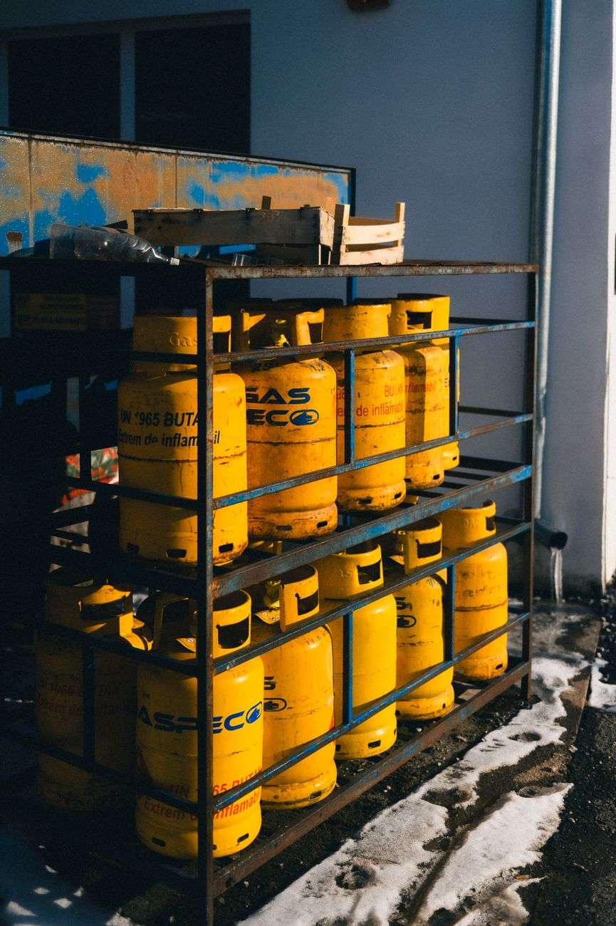 stacked yellow gas cylinders in industrial setting