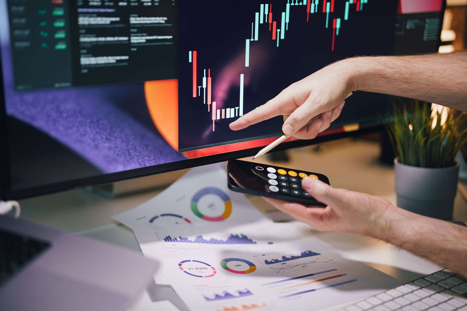 falls and rises on the stock exchange hand pointing at the chart