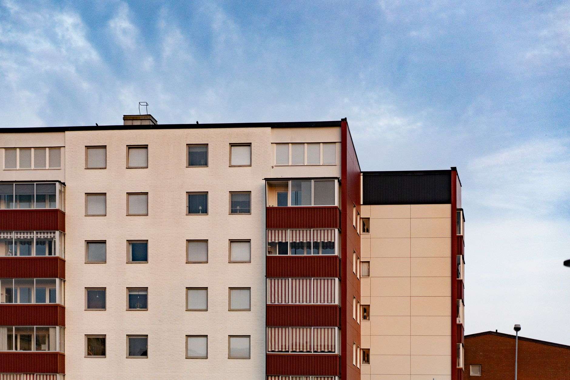a large apartment building with a red and white facade